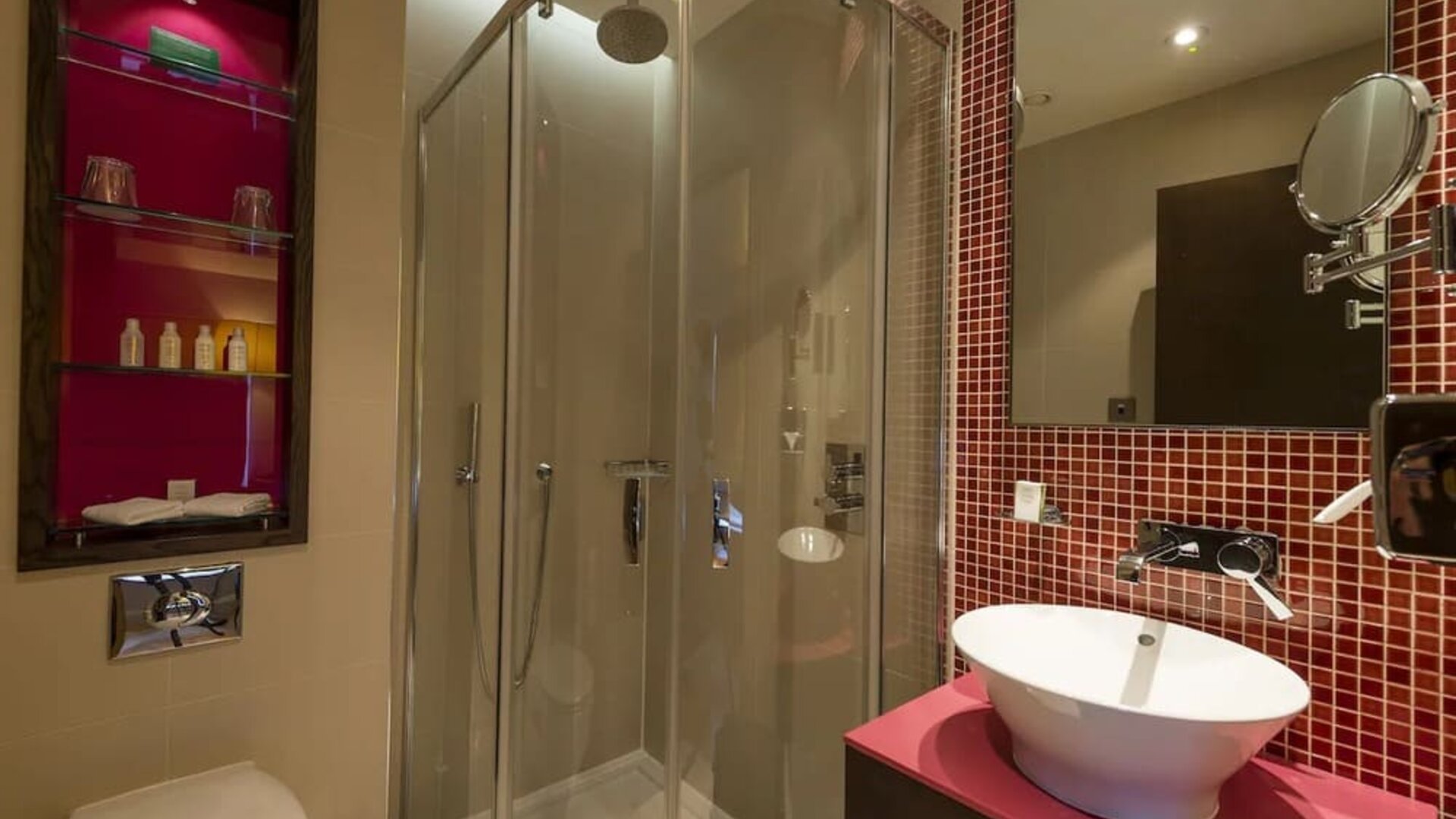 Guest bathroom with shower and free toiletries at Hotel Indigo London Paddington,