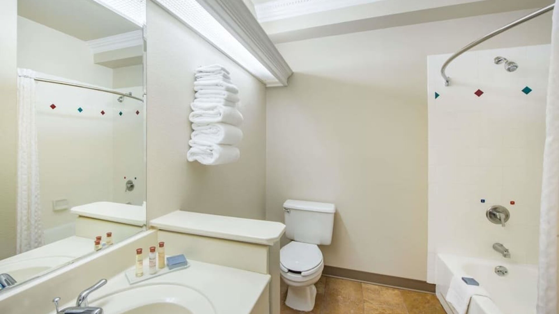 Guest bathroom with shower and tub at Hawthorn Suites By Wyndham El Paso Airport.