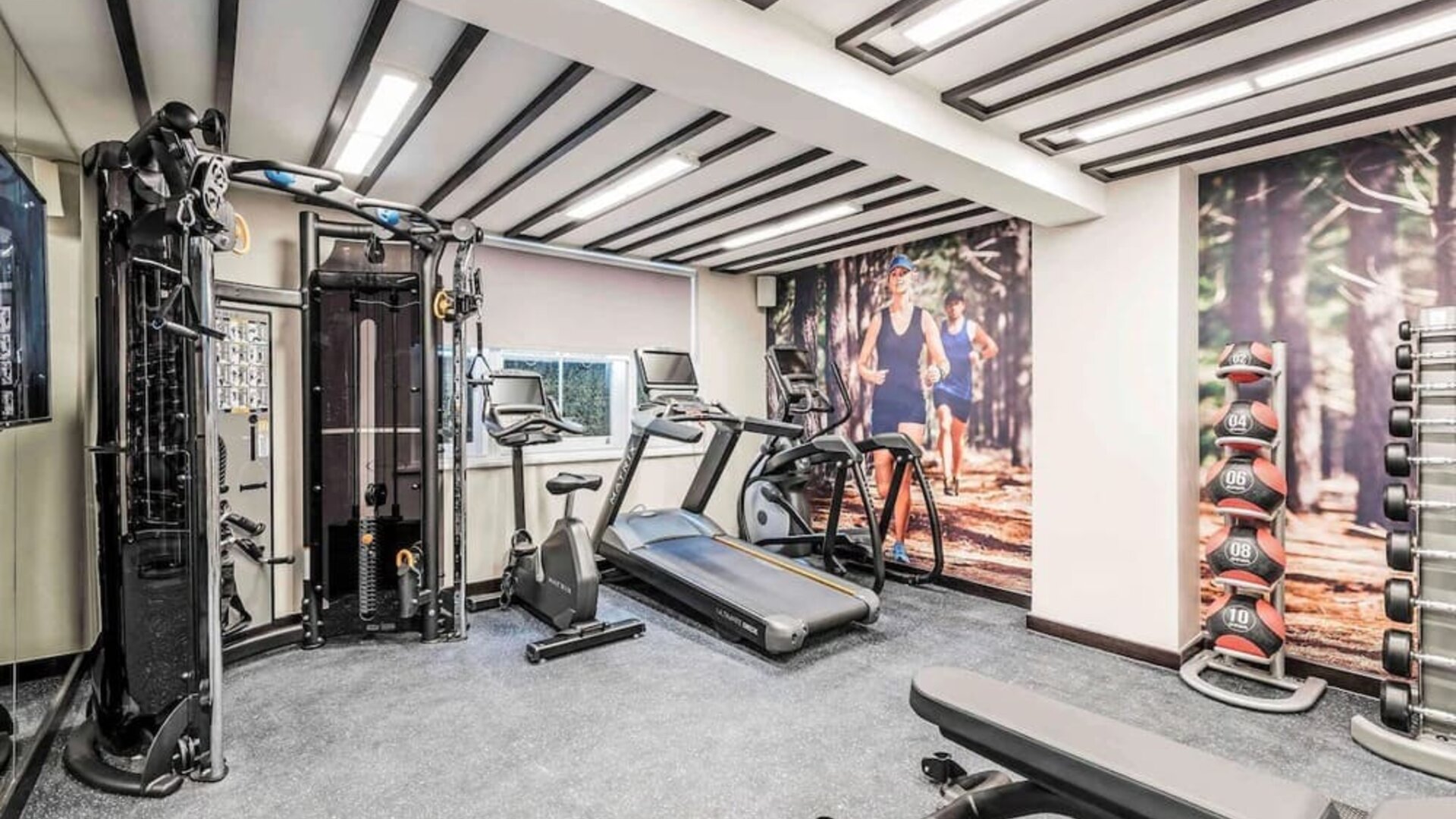 Fully equipped fitness center at Mercure Hotel London Hyde Park.