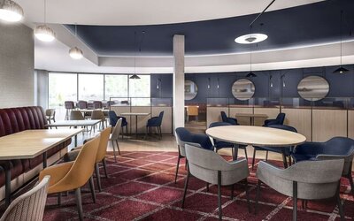 Dining area with comfortable seating, perfect for co-working at Hyatt Place London Heathrow Airport.
