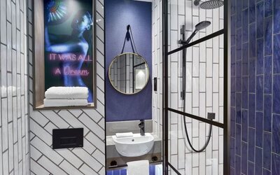 Guest bathroom with shower at NYX Hotel London Holborn By Leonardo.
