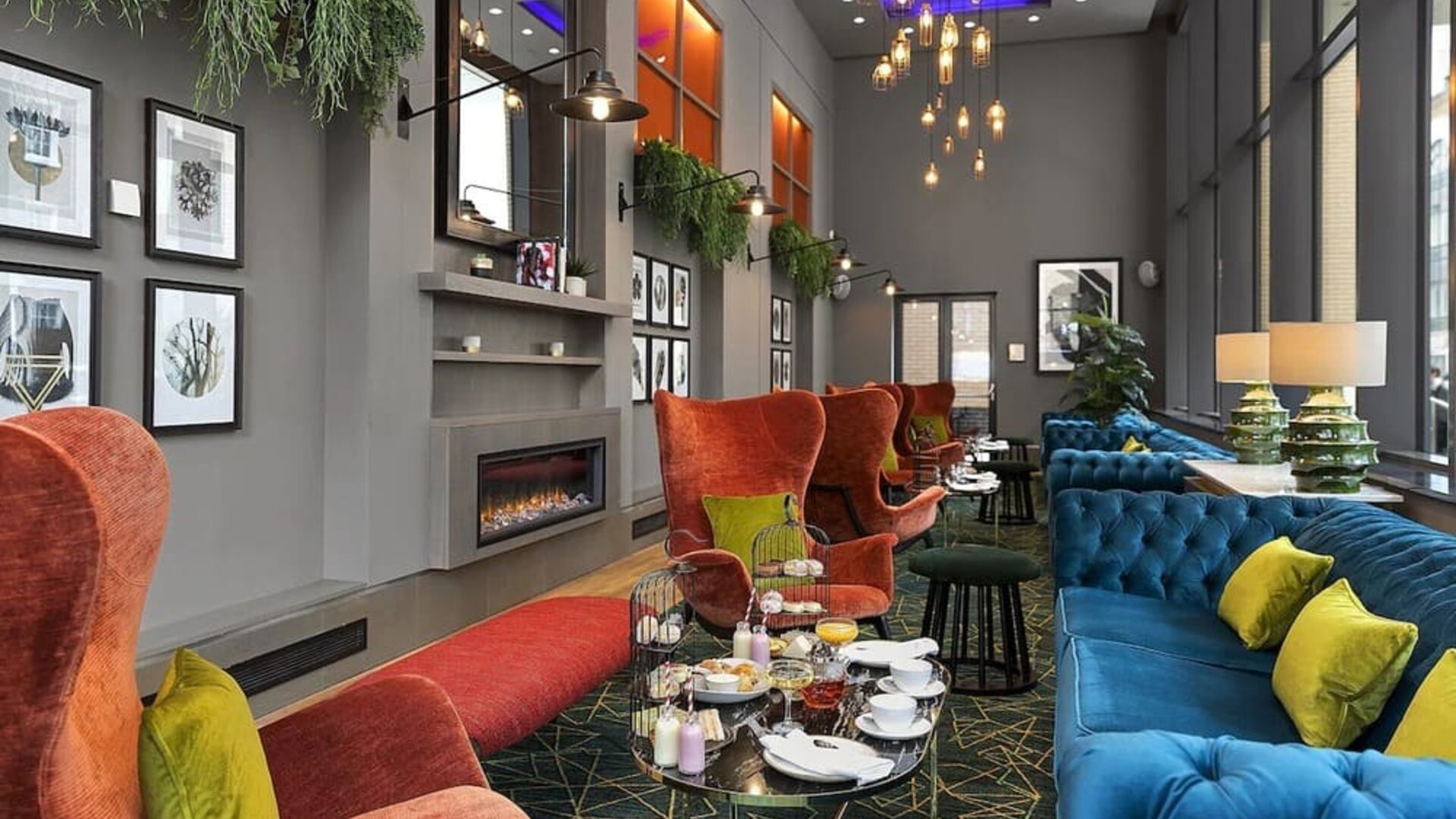 Stylish lobby lounge with comfortable seating and fireplace at Leonardo Royal Hotel London Tower Bridge.