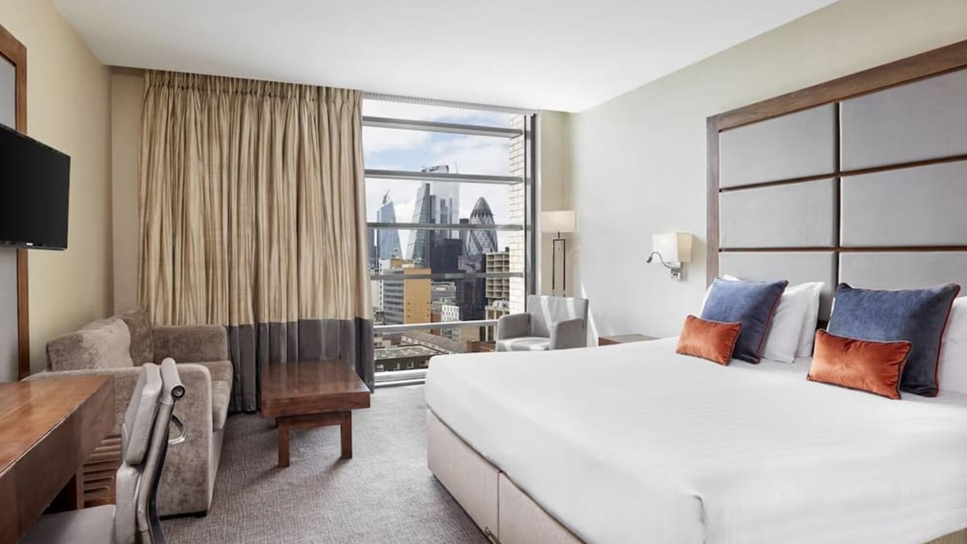 Day use room with TV, work desk and city view at Leonardo Royal Hotel London Tower Bridge.
