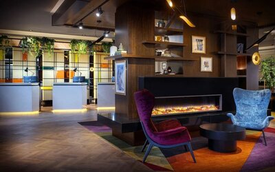 Lobby lounge with fireplace at Leonardo Royal Hotel London City.