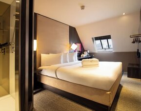 Day use room with king bed and private bathroom with shower at Bloc Hotel Birmingham.