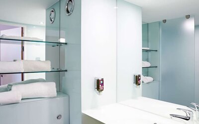 Guest bathroom with shower and free toiletries at Ibis Styles Barnsley.