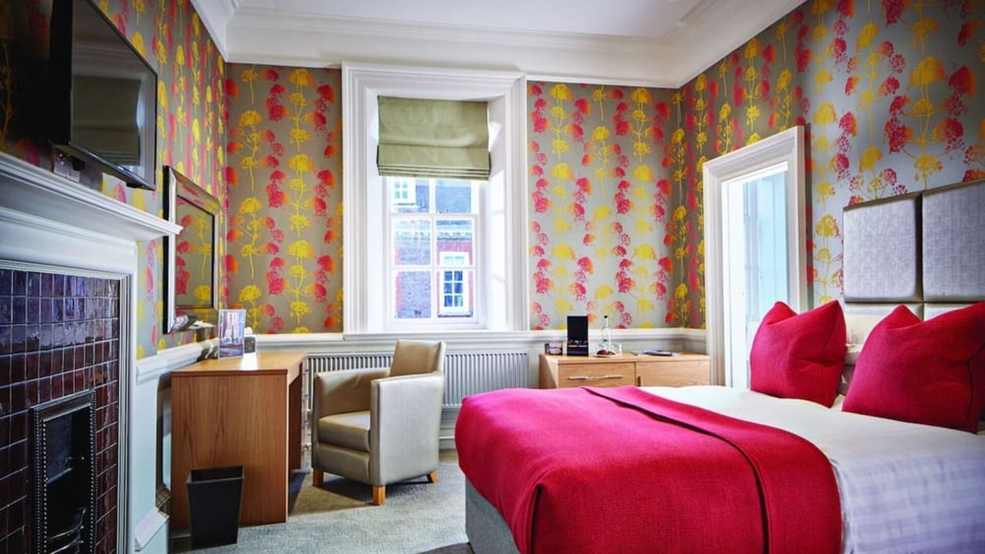 Day use room with work desk, TV screen and fireplace at Barnett Hill Hotel.