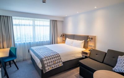 Day use room with work desk and lounge area at Holiday Inn Leicester-Wigston.