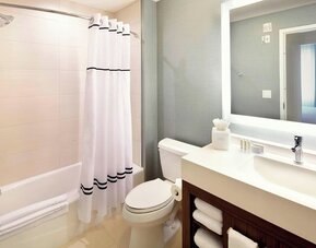 Guest bathroom with shower and tub at Residence Inn Secaucus.