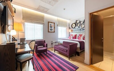 Day use room with work desk and lounge seating at Indigo London-Paddington Hotel.