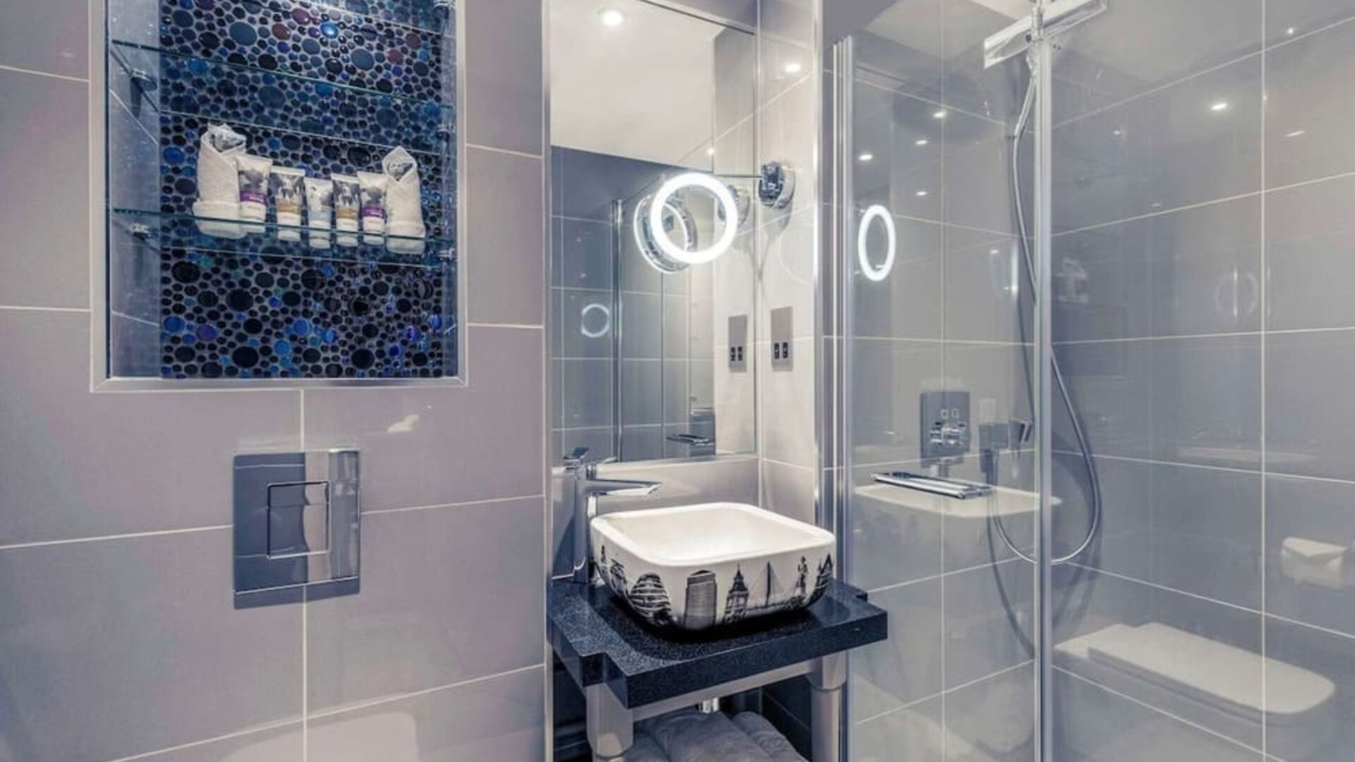 Guest bathroom with shower and free toiletries at Mercure London Hyde Park Hotel.