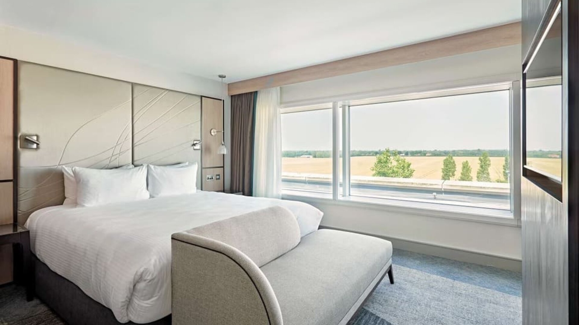 Day use room with TV screen, sofa and private bathroom at Hyatt Place London Heathrow Airport.