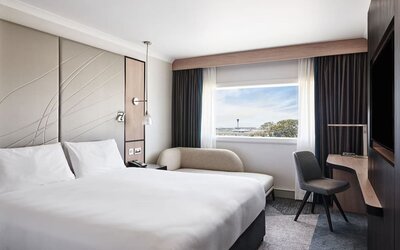 Day use room with sofa, work desk, TV screen and private bathroom