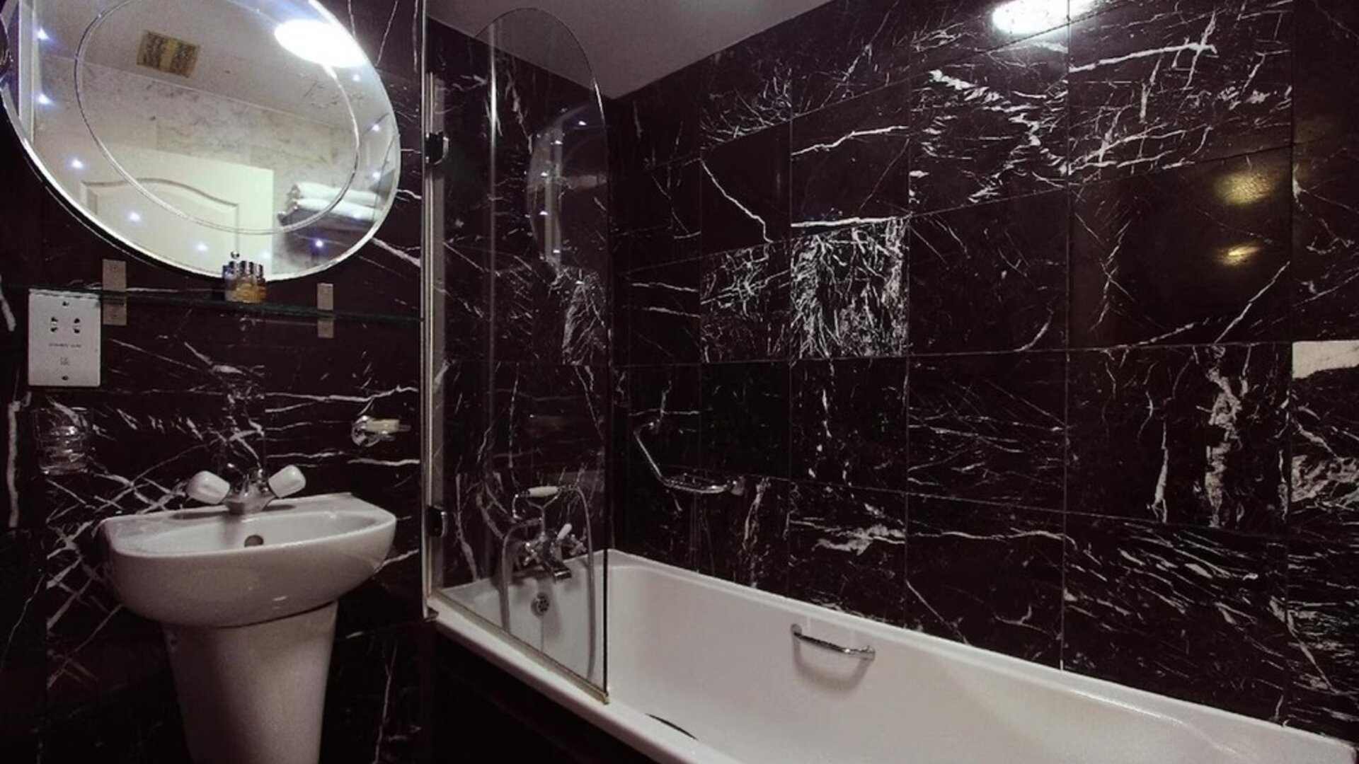 Guest bathroom with tub at Opulence Central London Hotel.