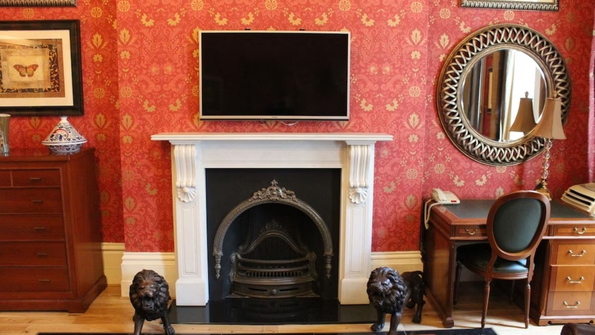 Day use senior suite's living area with fireplace and work desk at Opulence Central London Hotel.