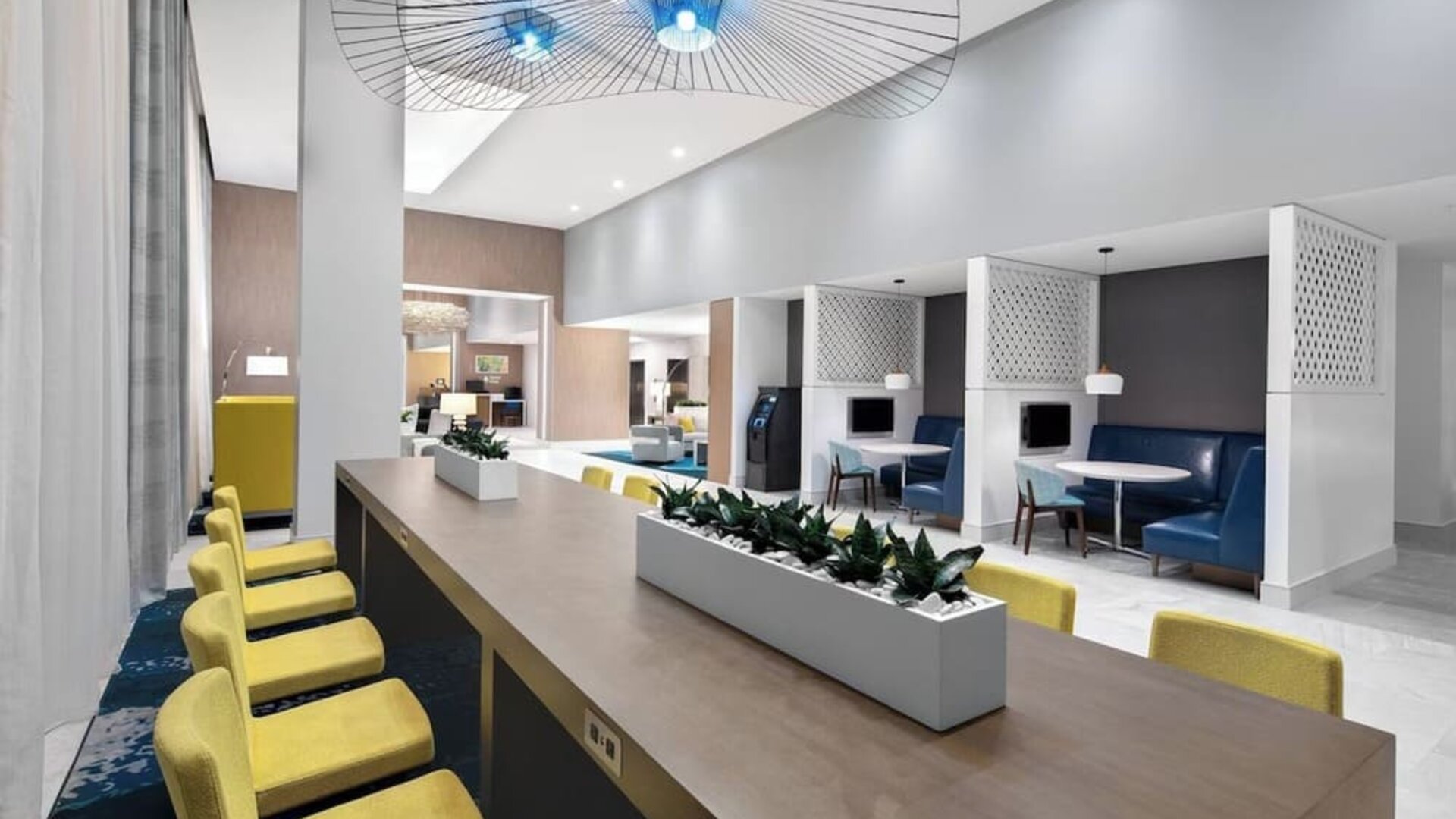 Media pods and lounge area at Courtyard Delray Beach.
