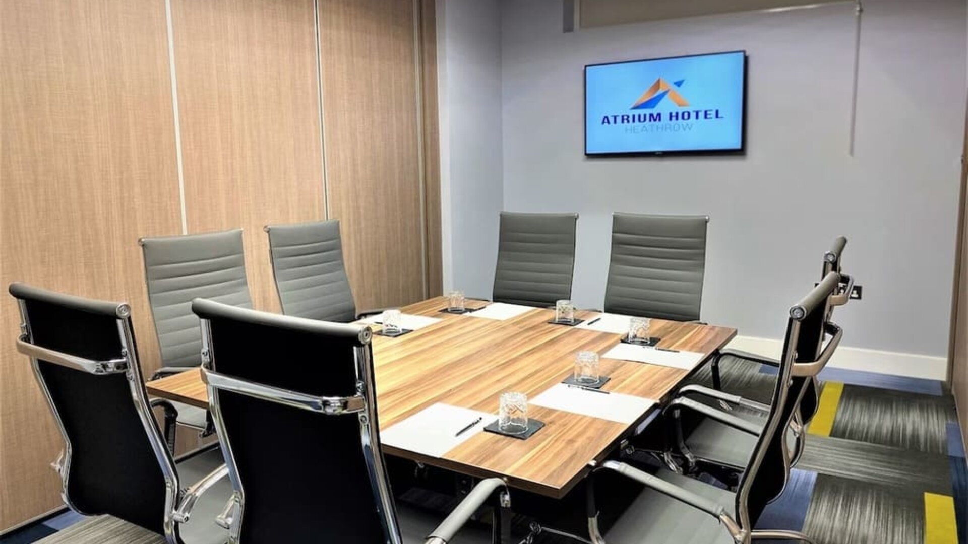 Professional meeting room with ergonomic chairs at Atrium Hotel Heathrow.