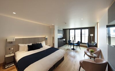 Day use executive suite with in-room kitchen, lounge seating and workspace at Tower Suites Hotel by Blue Orchid.