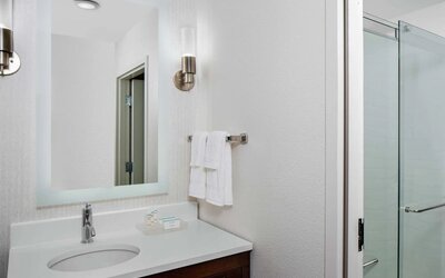 Guest bathroom with shower at Homewood Suites By Hilton Nashville.