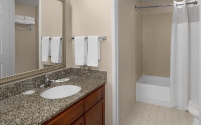 Guest bathroom with shower and tub at Residence Inn By Marriott San Diego Downtown.