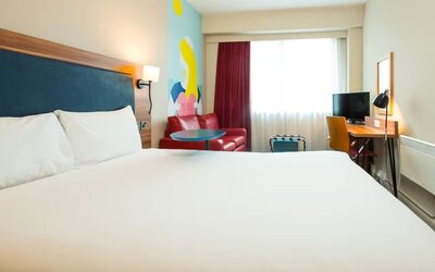 Day use room with work desk and sofa at ibis Styles Birmingham NEC.