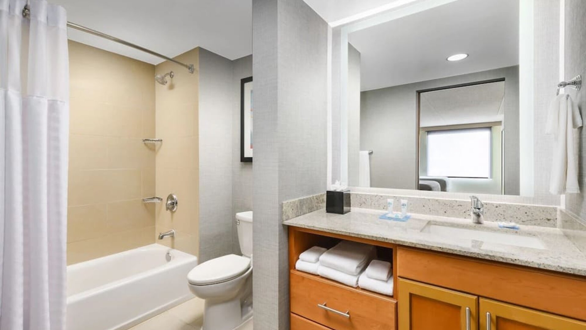 Guest bathroom with shower and tub at Hyatt HOUSE Fort Lauderdale Airport-South & Cruise Port.