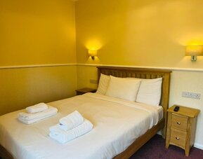 King bed at Rothwell House Hotel.
