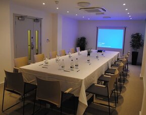 Professional meeting room at Pelican London Residence & Hotel.