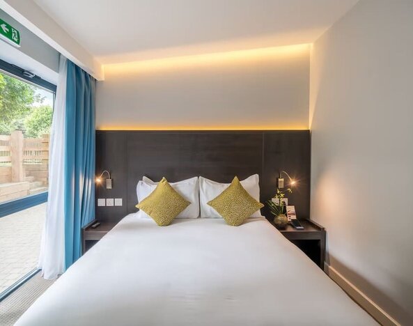 King bed at Pelican London Residence & Hotel.