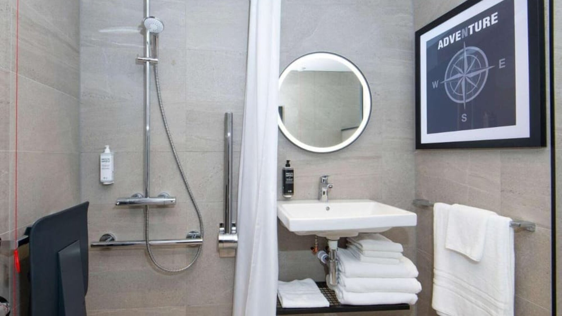 Private guest bathroom with shower at Ibis London Gatwick Airport Hotel. 