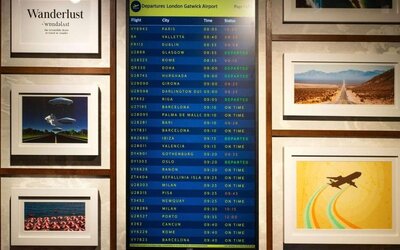 Lobby lounge with departures screen at Ibis London Gatwick Airport Hotel.