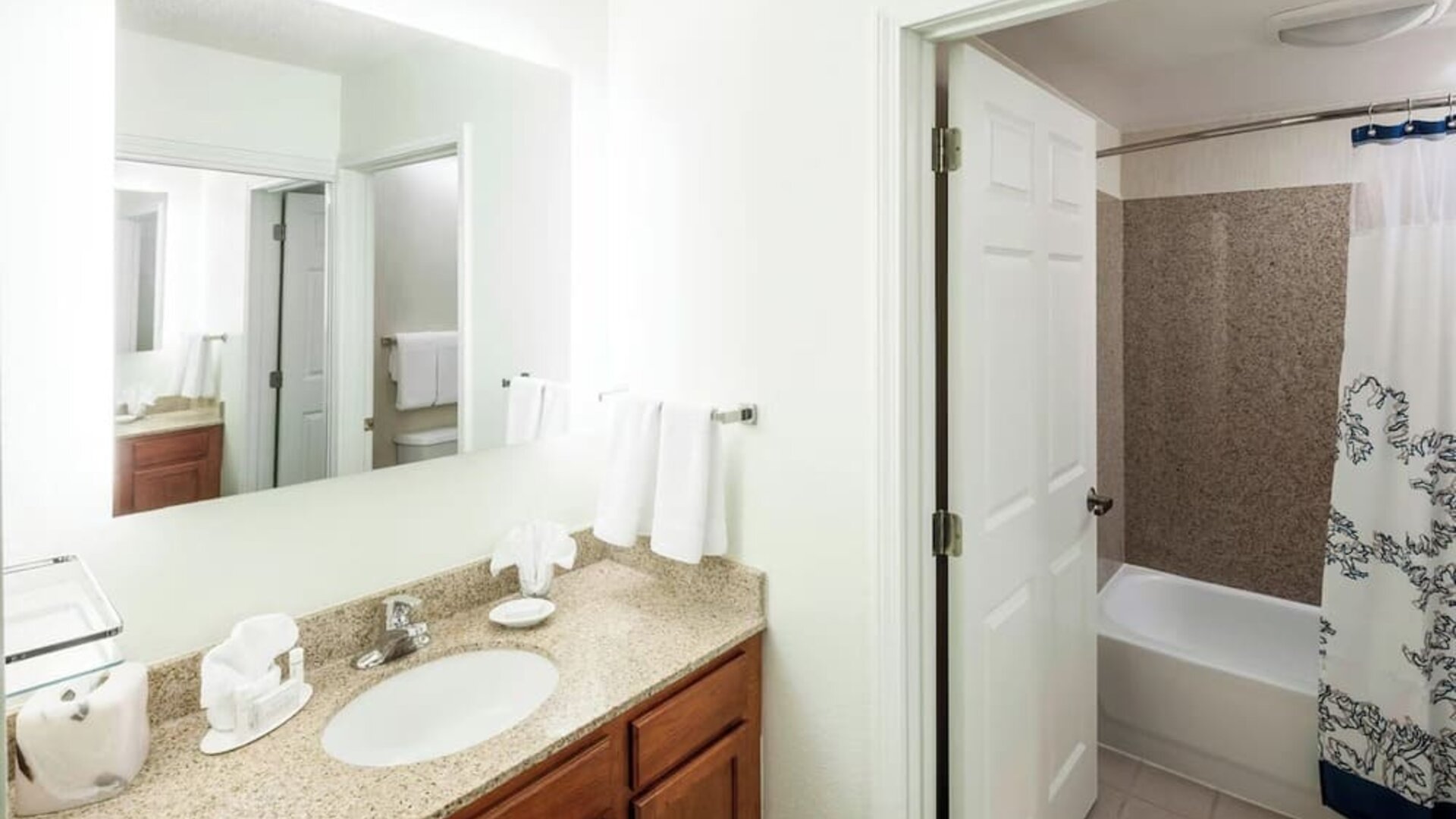 Guest bathroom with shower and tub at Residence Inn Kansas City Overland Park.