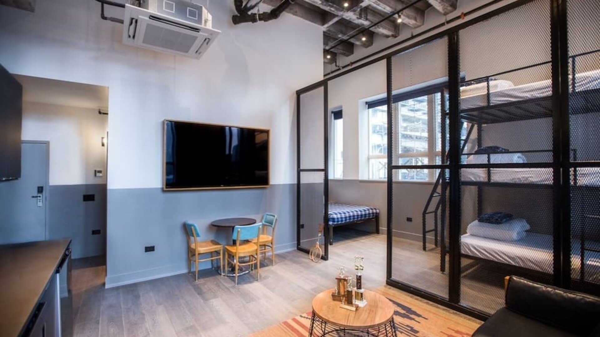 Day use room with three tier lofted bed, large living space and kitchenette at The Chicago Hotel Collection River North.