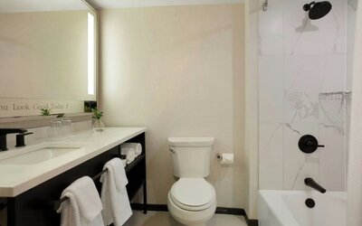 Guest bathroom with shower and tub at Renaissance Boca Raton Hotel.
