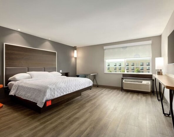 Spacious delux king bed with work desk at Tru By Hilton Wichita Northeast.
