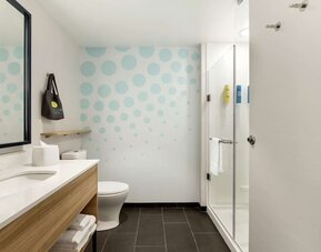 Guest bathroom with shower at Tru By Hilton Wichita Northeast.
