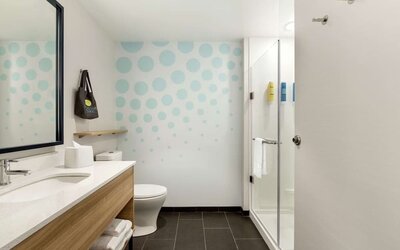 Guest bathroom with shower at Tru By Hilton Wichita Northeast.
