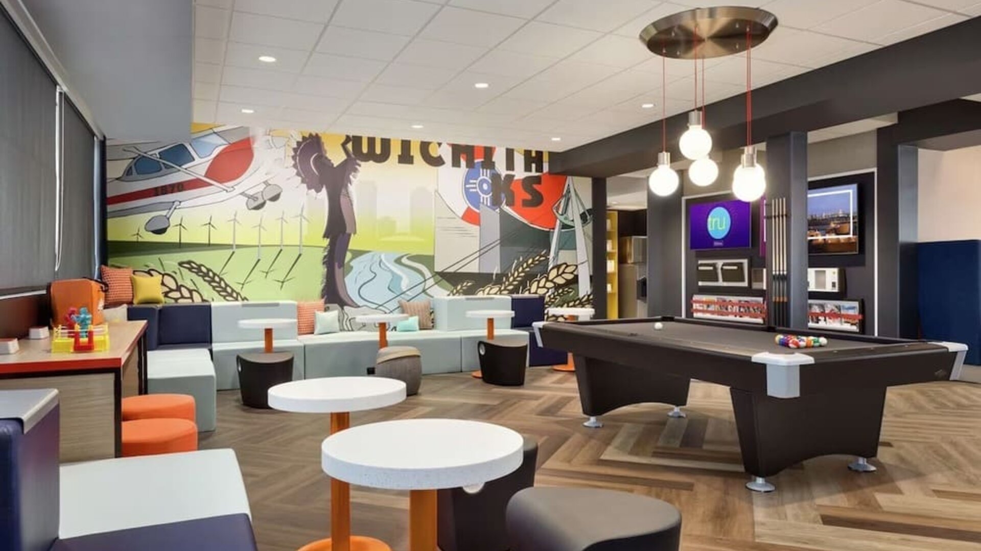Lobby, coworking lounge and billiards table at Tru By Hilton Wichita Northeast.
