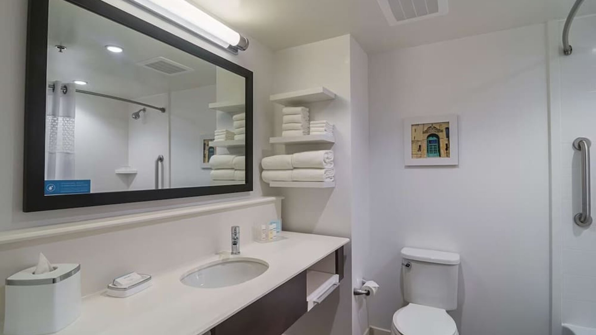 Guest bathroom with shower and tub at Hampton Inn Chicago North/Loyola Station.