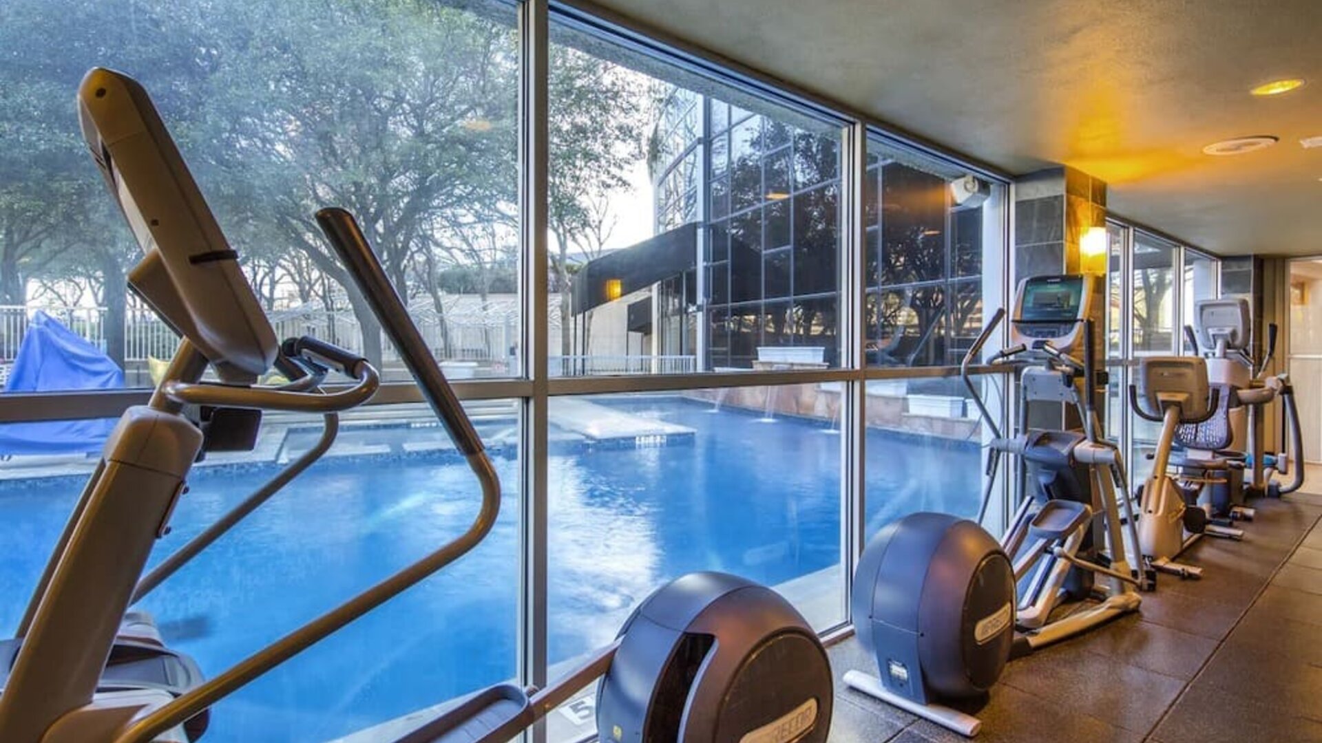 Fitness center overlooking the pool at Hilton Dallas Lincoln Centre.