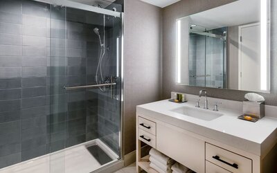 Guest bathroom with shower at Hilton Dallas Lincoln Centre.