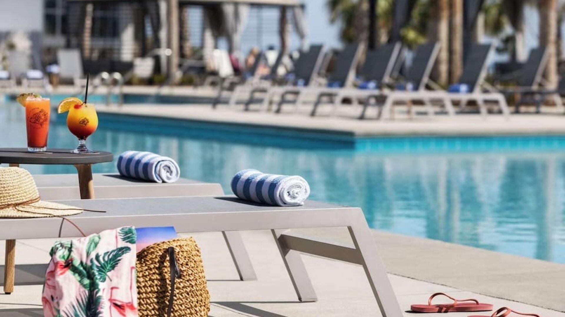 Sun loungers surrounding the pool at Embassy Suites By Hilton Myrtle Beach Oceanfront Resort.