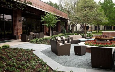 Firepit surrounded by outdoor furniture at Hilton Anatole.