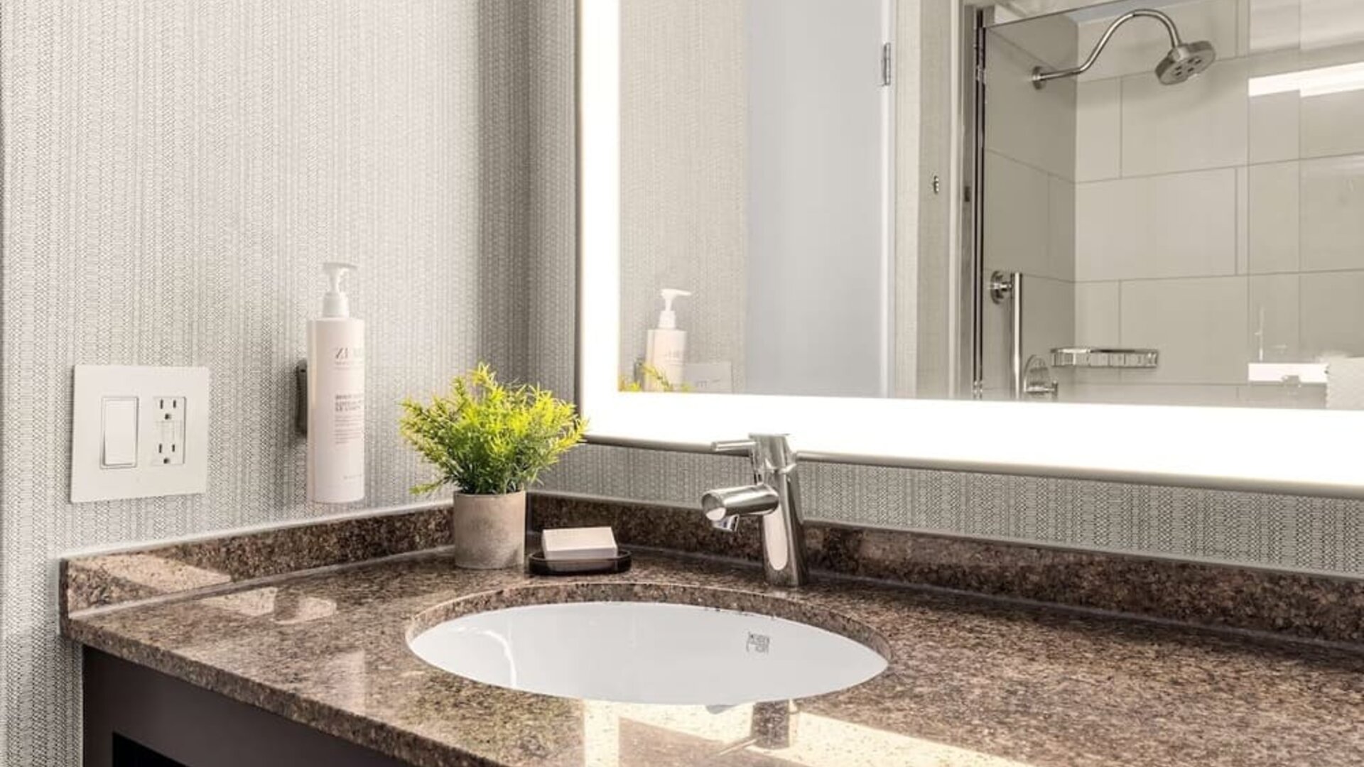 Guest bathroom with shower at Embassy Suites By Hilton Los Angeles International Airport South.