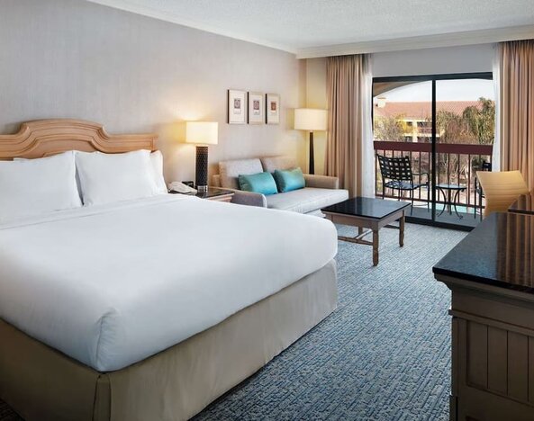 Day use room with work desk, sofa and balcony at DoubleTree By Hilton Sonoma Wine Country.
