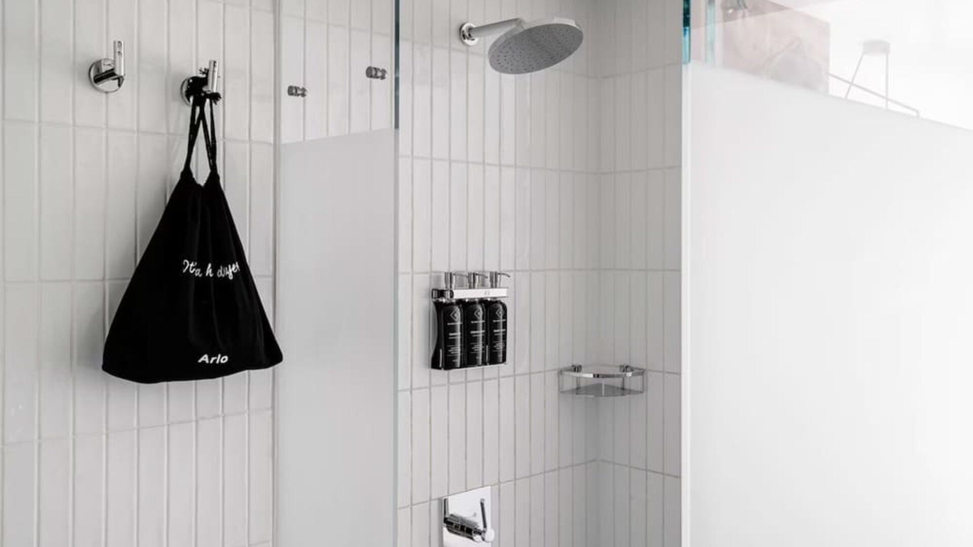 Private guest bathroom with shower and free toiletries at Arlo SoHo.