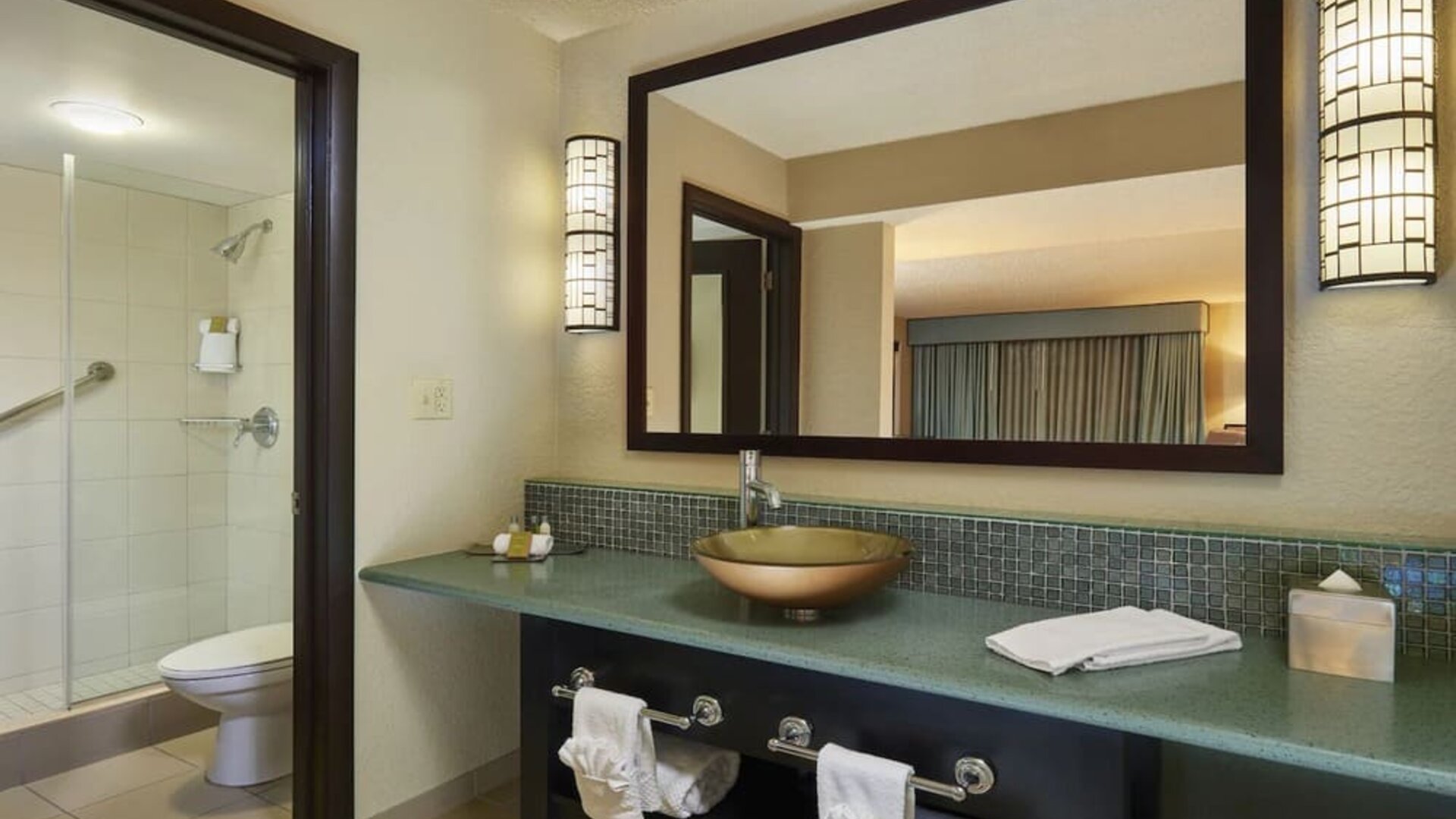 Guest bathroom with shower at DoubleTree By Hilton Orlando At SeaWorld.
