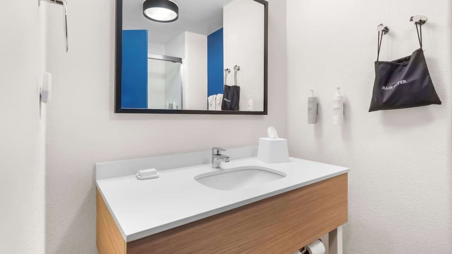 Private guest bathroom with shower and free toiletries at Spark By Hilton Pearland.
