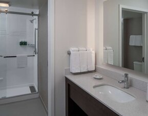 Private guest bathroom with shower and free toiletries at Sonesta ES Suites Fairfax Fair Lakes.