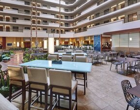 Breakfast area with natural light perfect for coworking at Embassy Suites By Hilton San Diego-La Jolla.